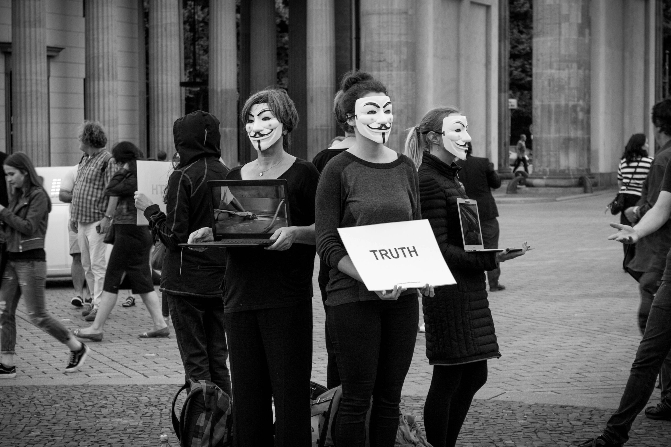 anonymous mail - people with mask with truth poster