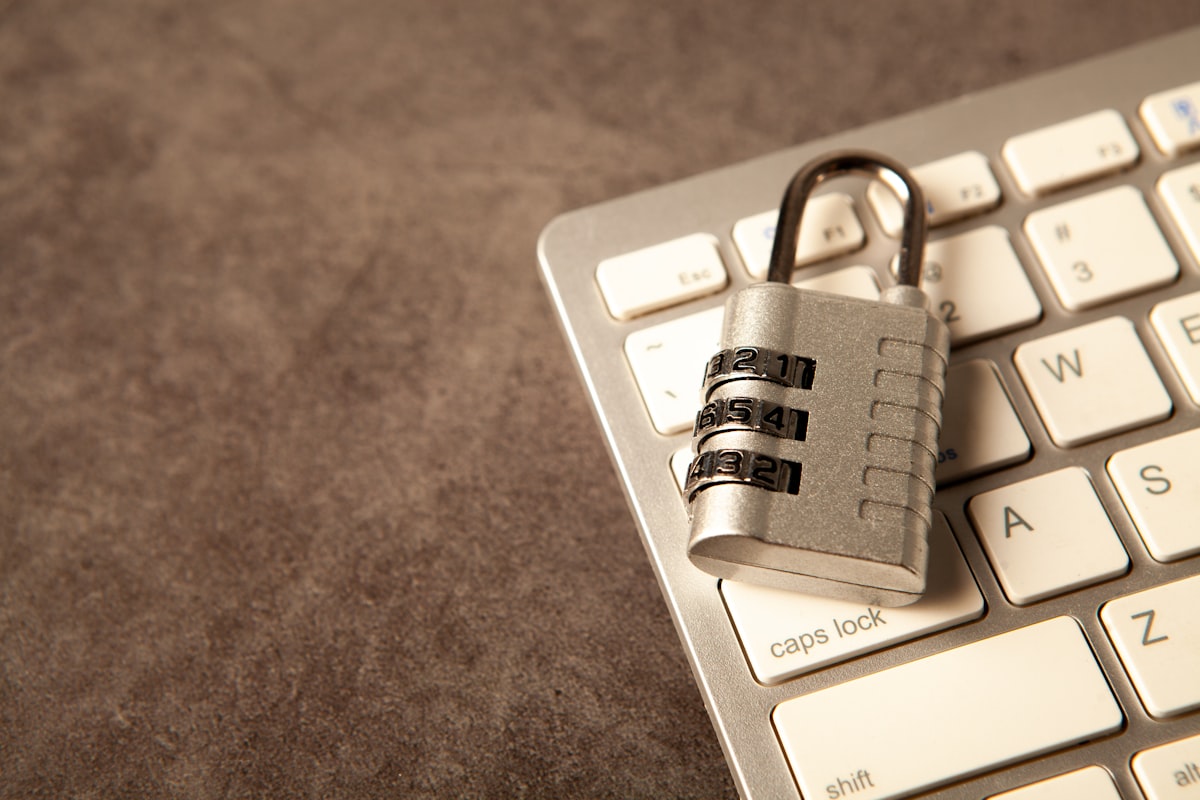 breached - A padlock rests on a computer keyboard.