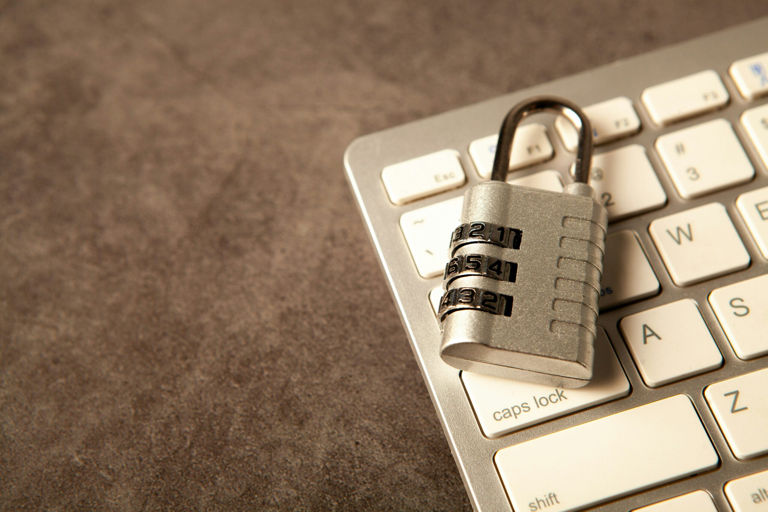 nomail - A padlock rests on a computer keyboard.